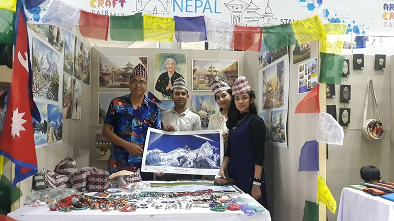 Nepali artist Dipendra Man Banepali handing over a painting to guest artists in the course of promoting Visit Nepal Year, 2020, at the International Art and Handicraft Exhibition, taking place in Dhaka, capital of Bangladesh, on Tuesday, November 26, 2019. Photo: RSS
