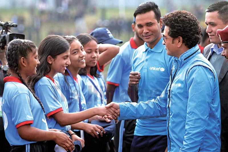 (Clockwise from left) Former Indian cricketer Sachin Tendulkar plays a shot; shakes hands with NSC Member Secretary Ramesh Kumar Silwal; and poses for group photo with children after a token match at the Tribhuvan University Stadium in Kathmandu on Saturday, November 16, 2019. Photo: Udipt Singh Chhetry/THT