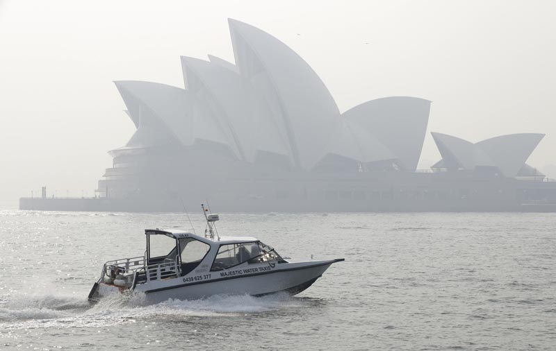 A water taxis drives by as smoke haze hangs over the Sydney Opera House in Sydney, Thursday, November 21, 2019. Photo: AP