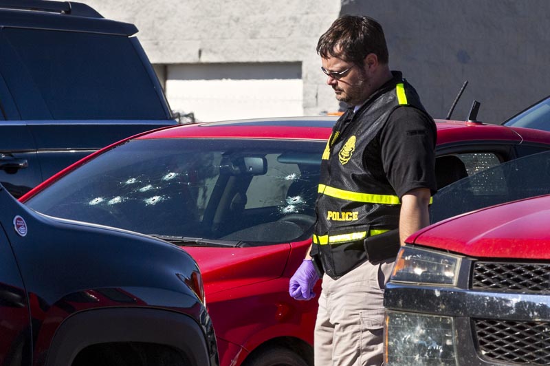 A member of the Oklahoma State Bureau of Investigation works the scene of a fatal shooting in the parking lot of a Walmart in Duncan, Oklahoma ,on Monday, November 18, 2019. Photo: Chris Landsberger/The Oklahoman via AP