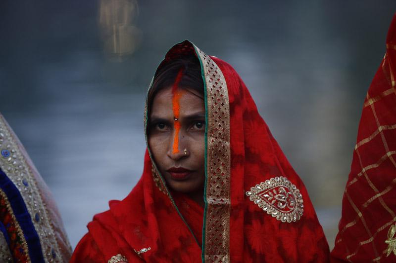 Women hold offerings as they offer prayers to the setting sun during Chhath festival at a pond in Kathmandu, Nepal on Saturday, November 02, 2019. Chhath festival is dedicated to the sun and ancient Vedic Goddess for ones good health, well being and prosperity. Photo: Skanda Gautam/THT