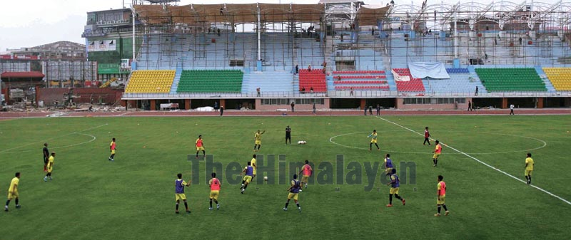 National football team players warming up during their training session for the prepartion of the 13th SAG at Dasharath Stadium, Tripureshowr in Kathmandu on Monday. Photo: THT