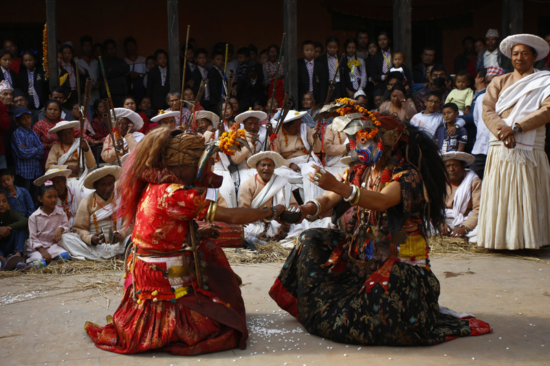 Nepali masked dancers clad as deities perform a traditional religious dance during Shikali festival at Khokana village in Lalitpur, Nepal on Tuesday, November 12, 2019. People clad as deities dance and drink blood of sacrificed animals as offerings to God in hope to receive blessings. Photo: Skanda Gautam/THT