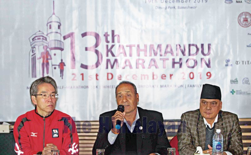 Chief organiser Nilendra Raj Shrestha speaks as Province-3 Tourism Minister Arun Prasad Nepal (right) and former athletics coach Kazuaki Naganuma look on during a press meet of the 13th Kathmandu Marathon on Thursday, December 19, 2019. Photo: THT