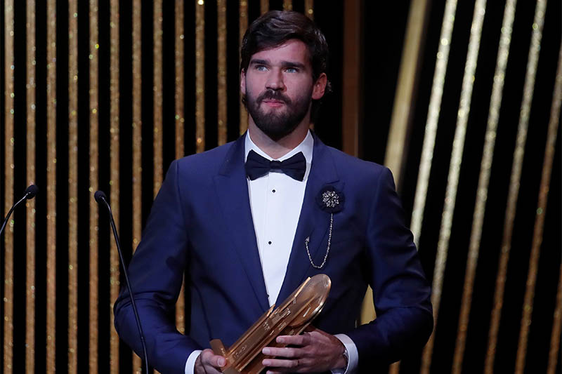 Liverpool's Alisson Becker with the Yachine Trophy. Photo: Reuters