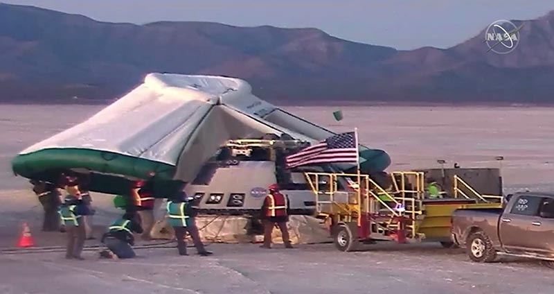 A tent is placed over the Boeing CST-100 Starliner spacecraft, which had been launched atop an ULA Atlas V rocket for an Orbital Flight Test, to protect it while being checked after landing by parachute at White Sands Space Harbor, New Mexico, US in a still image taken from a video December 22, 2019. Photo: NASA TV via Reuters