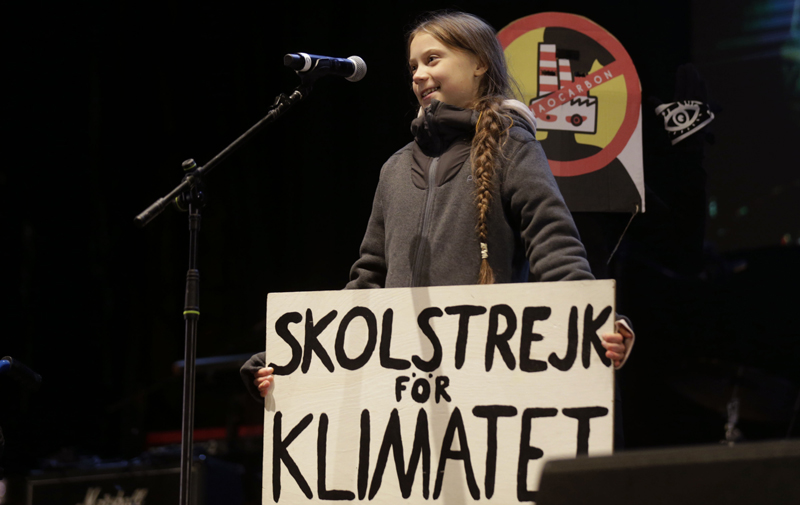 Climate activist Greta Thunberg speaks to assistants during a demonstration in Madrid, Friday Dec 6, 2019. Photo: AP
