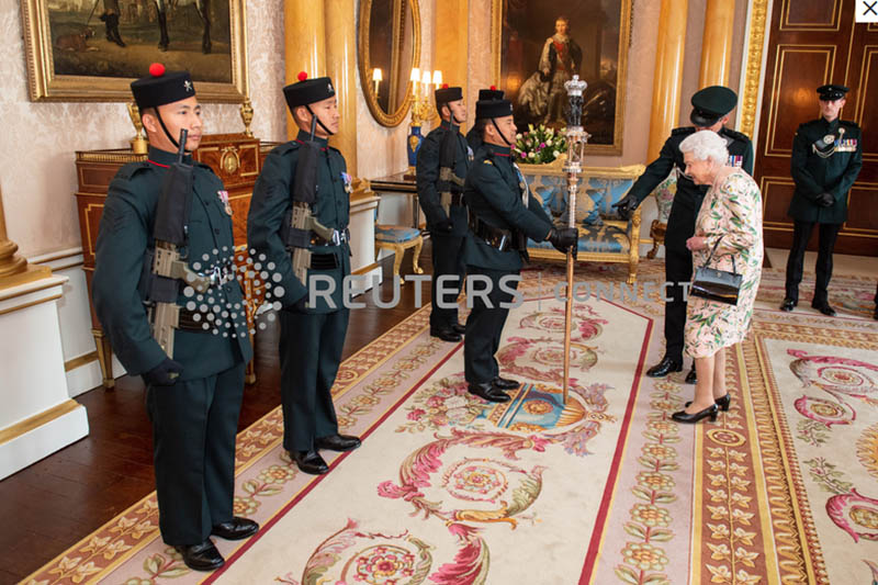 FILE: Queen Elizabeth II inspects the Queen's Truncheon, the ceremonial staff carried by the Royal Gurkha Riflies regiment, during an audience at Buckingham Palace, in London. Photo: Reuters