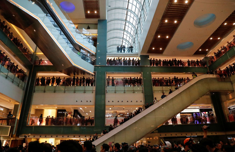 People watch as anti-government protesters stage a demonstration inside a mall, in Hong Kong, China December 15, 2019. Photo: Reuters