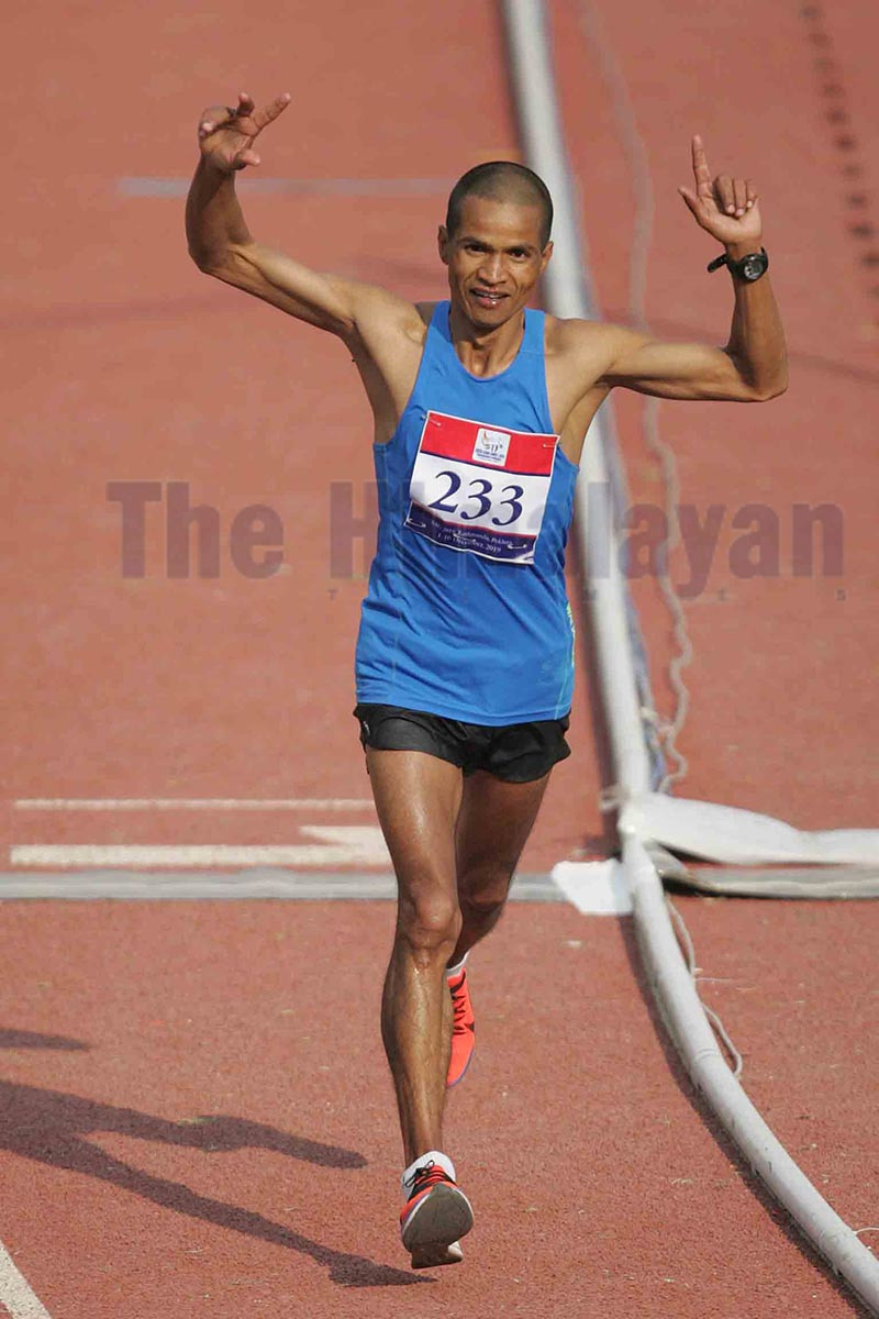 Kiran Singh Bogati celebrates after winning the menu2019s marathon during the 13th South Asian Games at Dasharath Stadium in Kathmandu, on Saturday. Photo: Udipt Singh Chhetry/ THT
