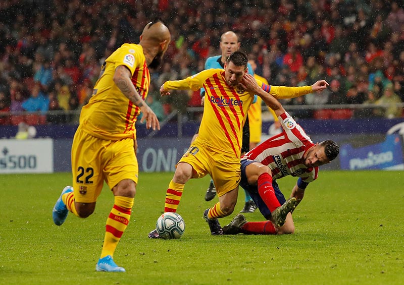 Barcelona's Lionel Messi in action with Atletico Madrid's Koke during the La Liga Santander match between Atletico Madrid and FC Barcelona, at Wanda Metropolitano, in Madrid, Spain, at December 1, 2019. Photo: Reuters