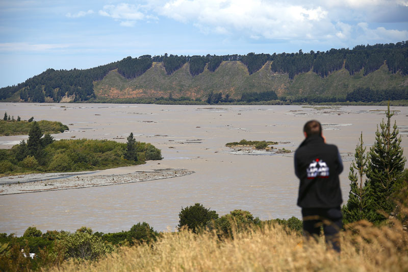 A tourist photographs the rising water in the Rakaia Gorge 85kms (50 miles) west of Christchurch in Canterbury, New Zealand as stormy weather across New Zealand over the weekend caused disruptions and road closures in many parts of the country, Sunday, Dec 8, 2019. Photo: David B Gray via AP