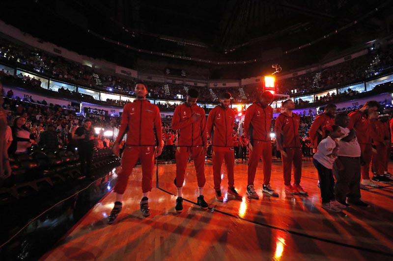 The New Orleans Pelicans pause during a moment of silence for Carley McCord, a sports journalist who was the in-game host for the Pelicans and who died in a plane crash Saturday, before the team's NBA basketball game against the Indiana Pacers in New Orleans, Saturday, December 28, 2019. Photo: AP