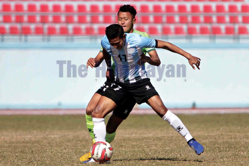 MMCu2019s Daya Nanda Singh (front) vies with TAC player during their Qatar Airways Martyrs Memorial A Division League match in Kathmandu on Monday, December 23, 2019. Photo: THT