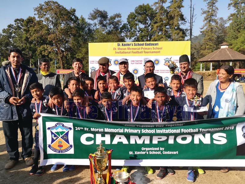 Maya Universe Academy players pose with officials as they celebrate after winning the 24th Father Moran Memorial Invitational Football Tournament at the St Xavieru2019s Godavari School grounds in Lalitpur on Saturday, December 21, 2019. Photo: THT