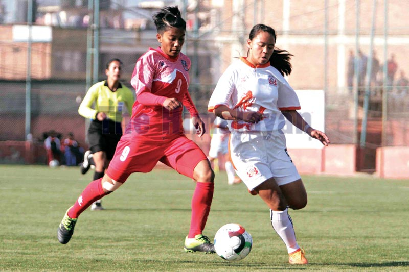 Nepal’s Amisha Karki (left) and Bhutan’s Tshering Yangchen vie for the ball during their U-15 girls’ friendly match at the ANFA Complex grounds in Lalitpur on Monday, December 23, 2019. Photo: Udipt Singh Chhetry/THT