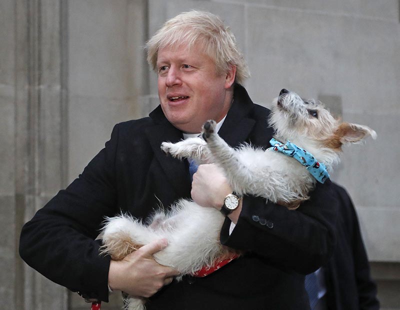 Britain's Prime Minister and Conservative Party leader Boris Johnson holds his dog Dilyn as he leaves after voting in the general election at Methodist Central Hall, Westminster, London, Thursday, December 13, 2019. Photo: AP
