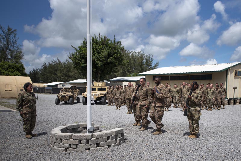 In this photo taken Aug. 26, 2019 and released by the U.S. Air Force, airmen from the 475th Expeditionary Air Base Squadron conduct a flag-raising ceremony, signifying the change from tactical to enduring operations, at Camp Simba, Manda Bay, Kenya. Photo: AP
