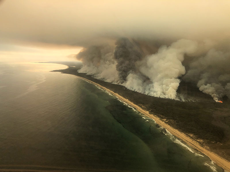 Thick plumes of smoke rise from bushfires at the coast of East Gippsland, Victoria, Australia January 4, 2020 in this aerial picture taken from AMSA Challenger jet. Photo: Reuters
