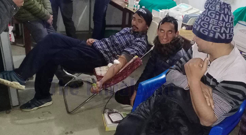 Two doctors donating blood to save a pregnant woman at district hospital, Bajura, on Saturday. Photo: THT