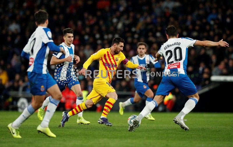 Barcelona's Lionel Messi in action with Espanyol's Bernardo Espinosa during the La Liga Santander match between Espanyol and FC Barcelona, at RCDE Stadium, in Barcelona, Spain, on January 4, 2020. Photo: Reuters