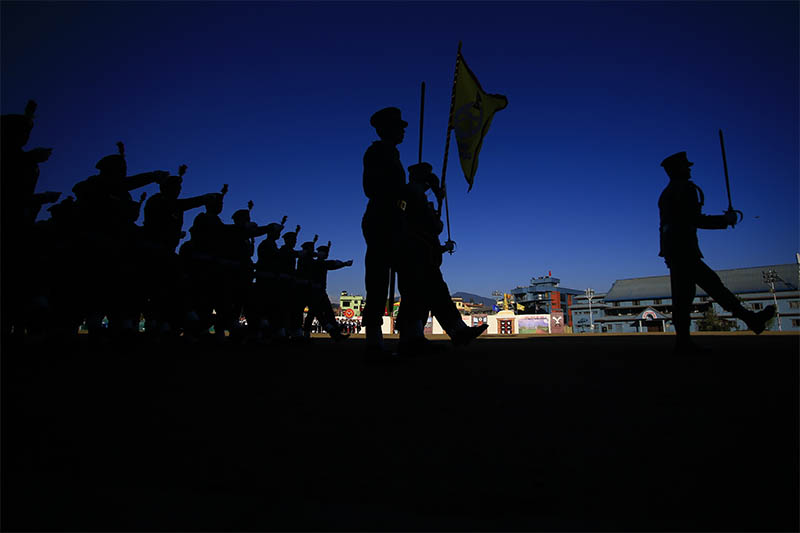 Nepal Armed Police Force (APF) personnel are silhouetted during a march past held to mark Armed Police Force Day at APF headquarters, in Kathmandu, on Thursday, January 23, 2020. Photo: Skanda Gautam/THT