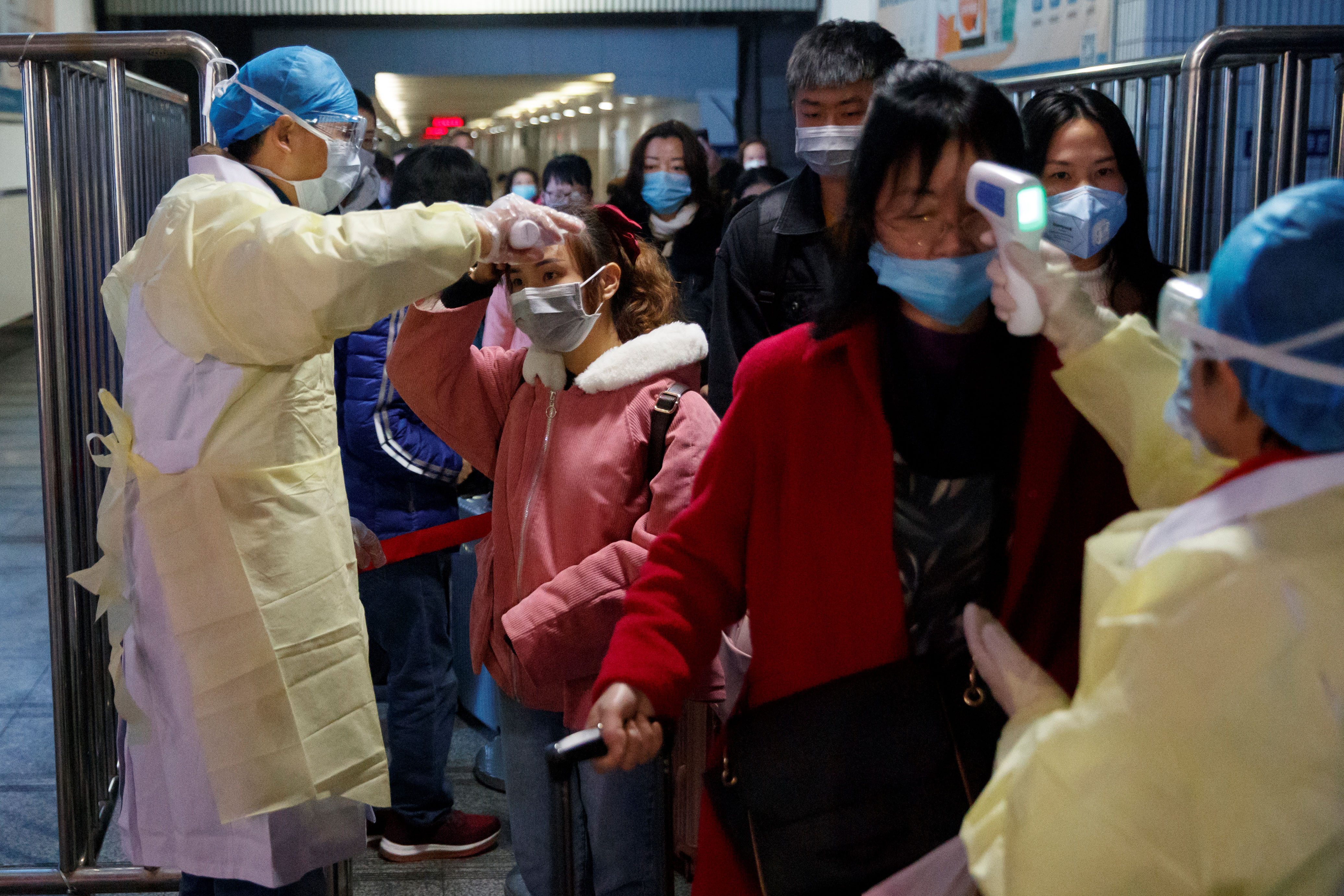 Medical workers take the temperature of passengers after they got off the train in Jiujiang, Jiangxi province, China, as the country is hit by an outbreak of a new coronavirus, January 29, 2020. Photo: Reuters