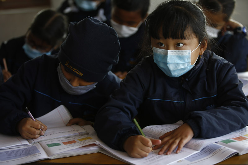 Grade 3 students wear face masks as a protective measure against coronavirus while studying in classroom, at Matribhumi School, in Thimi, Bhaktapur, on Wednesday, January 29, 2020. Photo: Skanda Gautam/THT