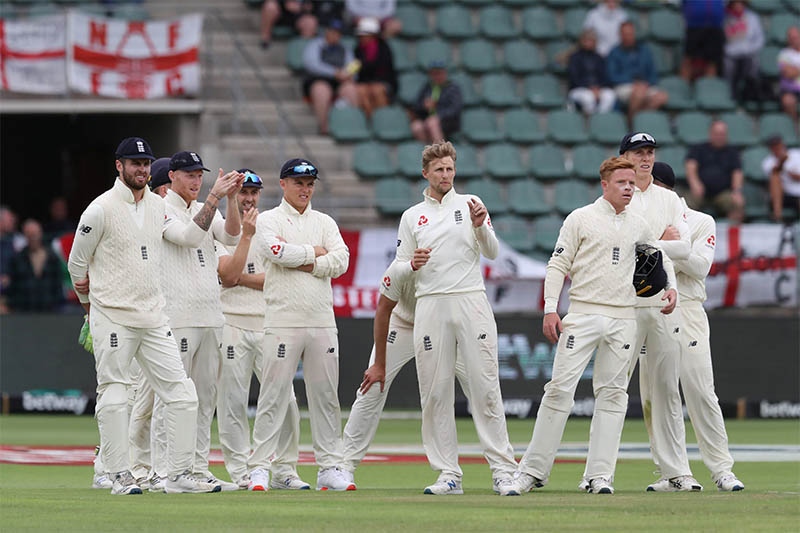 England players await the results of a review which rules that Joe Root has taken the wicket of South Africa's Pieter Malan. Photo: Reuters