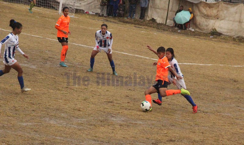 Nepal APF Clubu2019s Sabitra Bhandari shoots the ball under pressure from Tribhuvan Army Club players during Ridamahang-Ramalihang Aathpahariya first Womenu2019s Gold Cup final match in Dhankuta on Friday. Photo: THT