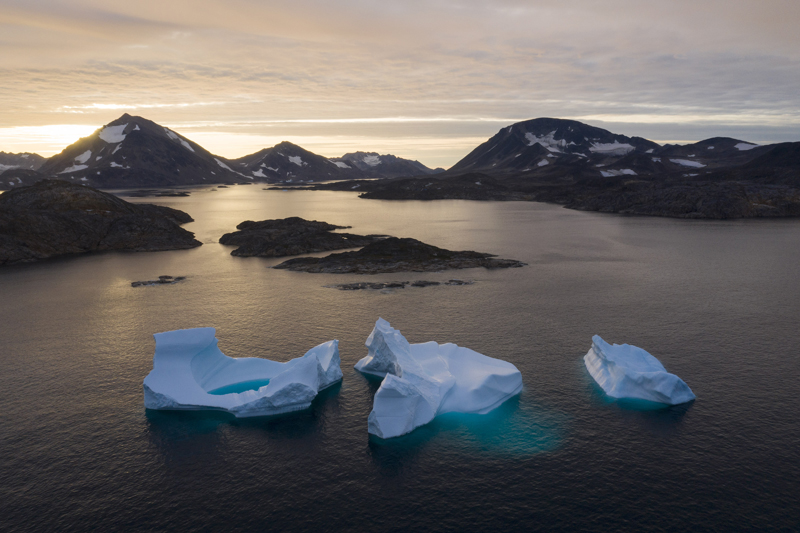 Large icebergs float away as the sun rises near Kulusuk, Greenland, Aug 16, 2019. Photo: AP/File