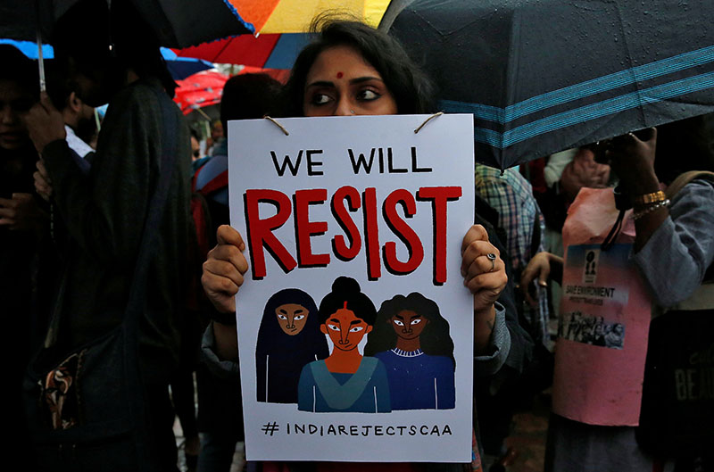 A demonstrator displays a placard as she attends a protest rally against a new citizenship law, in Kolkata, India, January 3, 2020.Photo: Reuters