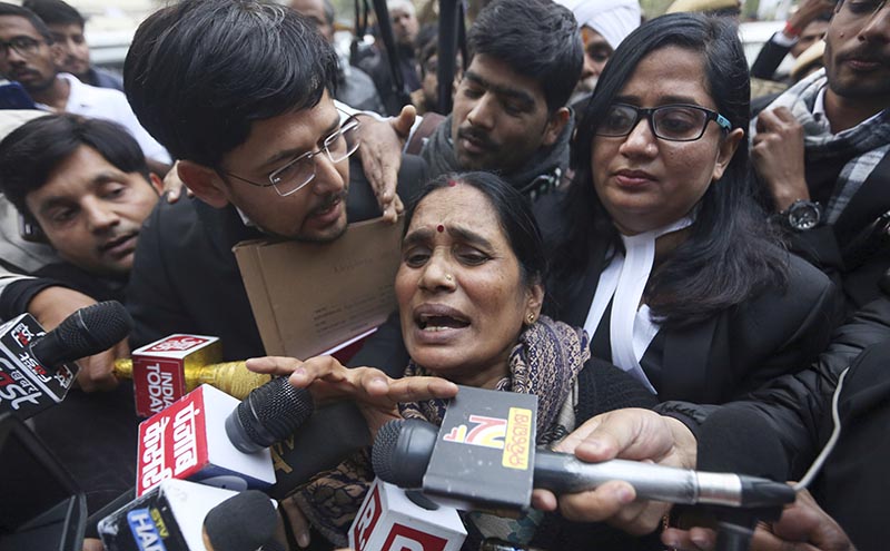 Asha Devi, mother of the victim of the fatal 2012 gang rape on a moving bus, speaks to the media as she leaves a court in New Delhi, India, on Tuesday, January 7, 2020. A death warrant was issued Tuesday for the four men convicted in the 2012 gang rape and murder of a young woman on a New Delhi bus that galvanized protests across India and brought global attention to the country's sexual violence epidemic. A New Delhi court scheduled the hangings for January 22, the Press Trust of India news agency reported. Photo: AP