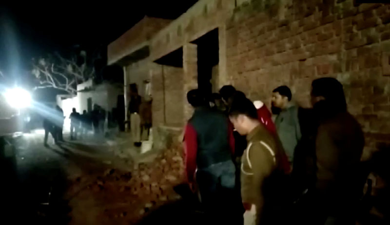 Residents and police personnel stand outside the building where a man has held hostages in Farrukhabad, Uttar Pradesh, India January 30, 2020 0 in this still image taken from video. ANI via Reuters
