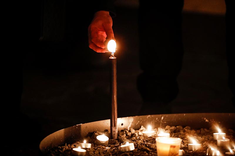 A person lights a candle at a memorial service for the victims of the Ukrainian Airlines plane crash in Iran, at the Great Cathedral in Stockholm, Sweden January 15, 2020. Photo: TT News Agency/Christine Olsson via Reuters