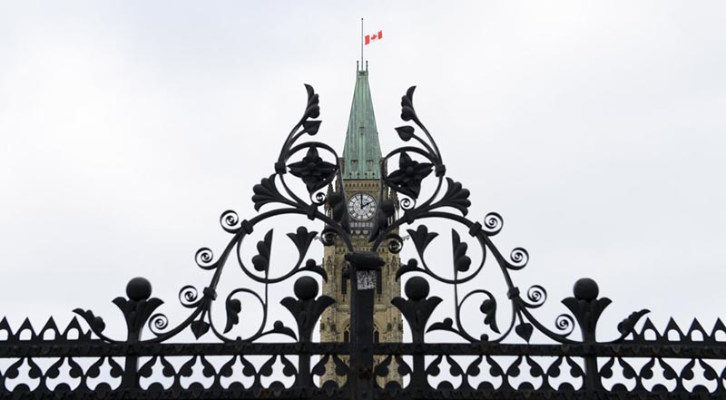 The Canadian flag flies at half-staff above the Parliament Hill Peace Tower flag in Ottawa, Wednesday, Jan. 8, 2020. Photo: Sean Kilpatrick/The Canadian Press via AP