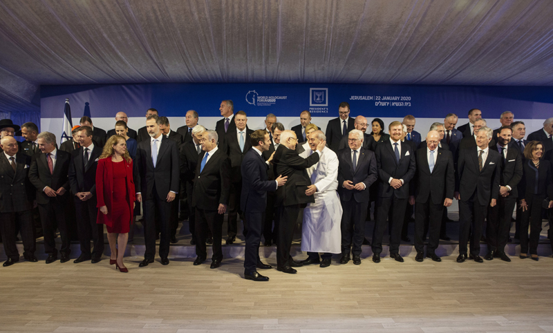 World leaders pose for a group photograph following a dinner reception as Israel's President Reuven Rivlin, centre, thanks his chef at his official residence in Jerusalem on Wednesday, January 22, 2020. Dozens of world leaders descended upon Jerusalem Thursday for the largest-ever gathering focused on commemorating the Holocaust and combating modern-day anti-Semitism. Photo: Heidi Levine/Pool photo via AP