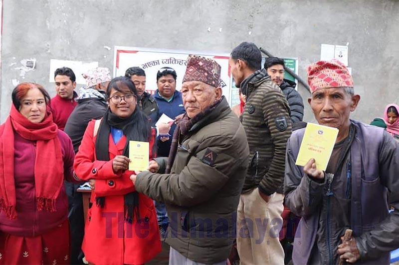 Ward Chair Khambajung Shah of Bheri Municipality giving away ID cards to differently-abled people, in Jajarkot district, on Monday, January 13, 2020. Photo: THT