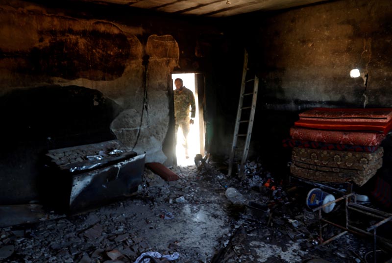 A fighter loyal to Libya's UN-backed government (GNA) looks at a room burned during clashes with troops loyal to Khalifa Haftar in Wadi Rabiya neighbourhood at outskirts of Tripoli, Libya May 28, 2019. Photo: Reuters