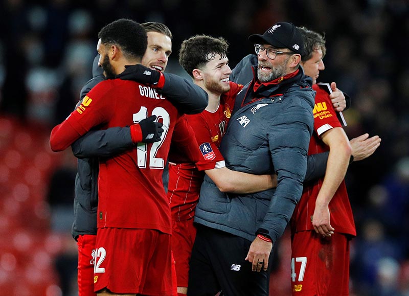 Liverpool's Neco Williams celebrates with manager Juergen Klopp after the match during the FA Cup Third Round match between Liverpool and Everton, at Anfield, in Liverpool, Britain, on January 5, 2020. Photo: Reuters