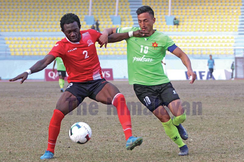 Tribhuvan Army Clubu2019s George Prince Karki (right) vies for the ball with Saraswoti Youth Clubu2019s Mbei Andre Ekwem during theri Qatar Airways Martyrs Memorial A Division League match in Kathmandu on Thursday. Photo: Udipt Singh Chhetry/ THT