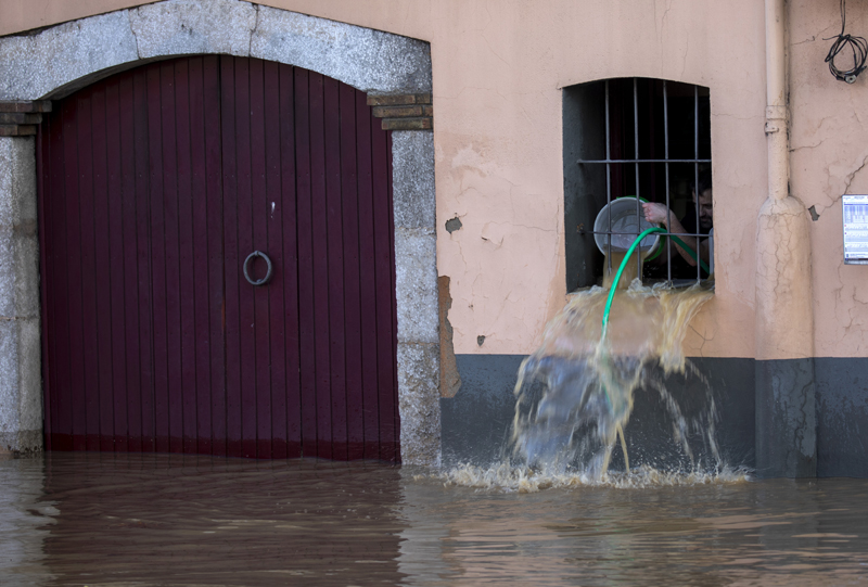 A man removes water from his house during flooding following a storm in Girona, Spain, on Thursday, Jan 23, 2020. Photo: AP