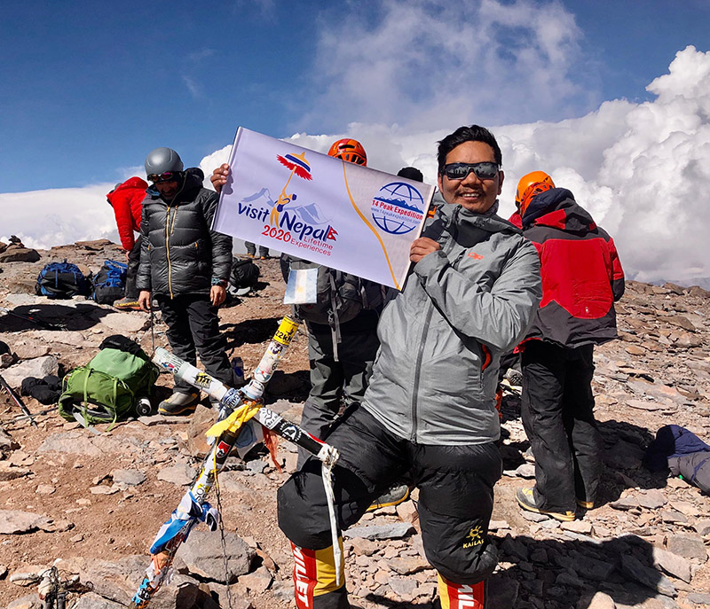 Managing Director of Seven Summit Treks, Tashi Lakpa, with Visit Nepal-2020 banner. Photo Courtesy: Seven Summit Treks.
