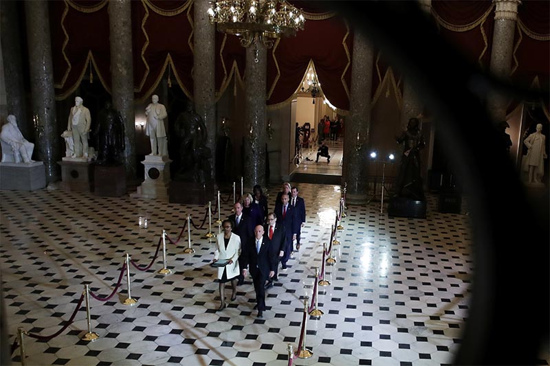 US House of Representatives Clerk Cheryl Johnson and House Sergeant at Arms Paul Irving carry two articles of impeachment against US President Donald Trump during a procession with the seven US House impeachment managers through Statuary Hall in the US Capitol in Washington, US, on January 15, 2020. Photo: Reuters