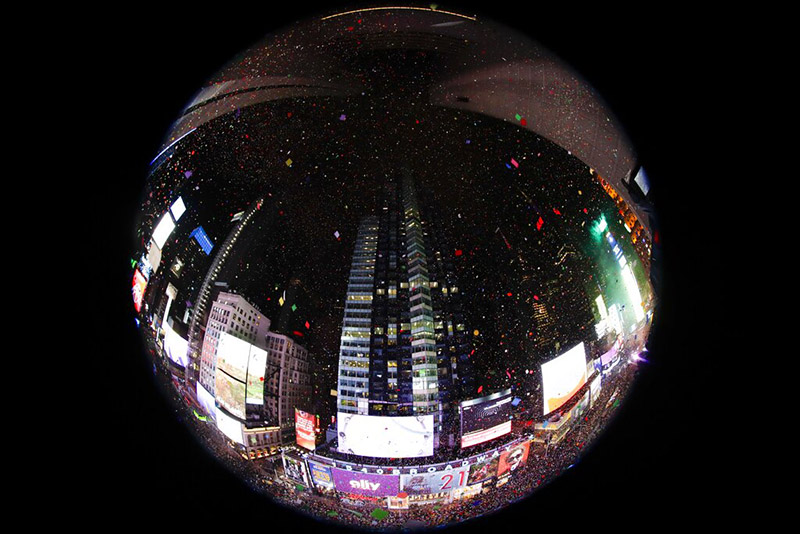 In an image taken with a fisheye lens, confetti drops over the crowd as the clock strikes midnight during the New Year's celebration as seen from the New York Marriott Marquis in New York's Times Square, Wednesday, January 1, 2020. Photo: AP