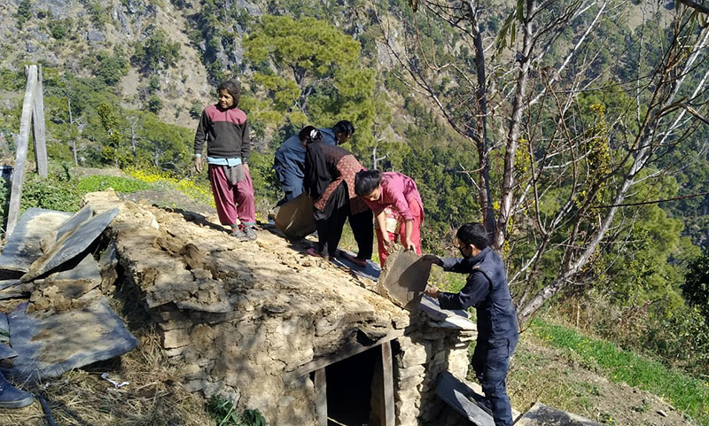 Locals along with security personnel destroying 'chhau' huts in Achham district. Photo: Prakash Singh/THT