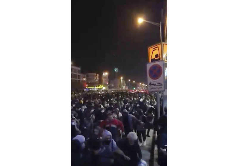 This image from a Sunday, Jan. 12, 2020 video provided by the New York-based Center for Human Rights in Iran shows a crowd fleeing police near Azadi, or Freedom, Square in Tehran, Iran. Iranian demonstrators defied a heavy police presence Sunday night to protest their country's days of denials that it shot down a Ukrainian passenger plane carrying 176 people, the latest unrest to roil the capital amid soaring tensions with the United States. Photo: AP