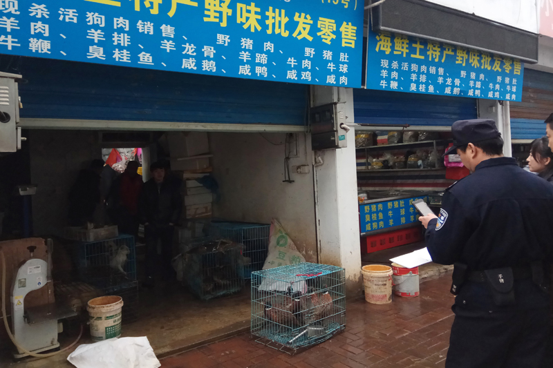 Police gather outside a store suspected of trafficking in wildlife in the city of Guangde in central Chinau0092s Anhui province, Jan 9, 2020. Photo: Anti-Poaching Special Squad via AP/File