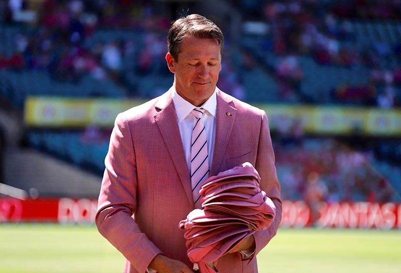 Former Australian cricketer Glenn McGrath holds the England team's pink test caps as part of a charity event before the start of the third day of the fifth Ashes cricket test match. Photo: Reuters