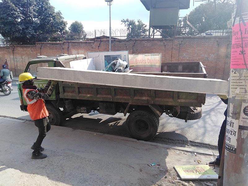 Kathmandu Metropolitan City workers loading hoarding boards onto a vehicle in Anamnagar, Kathmandu, on January 30, 2020. Photo: Sandeep Sen/ THT Online